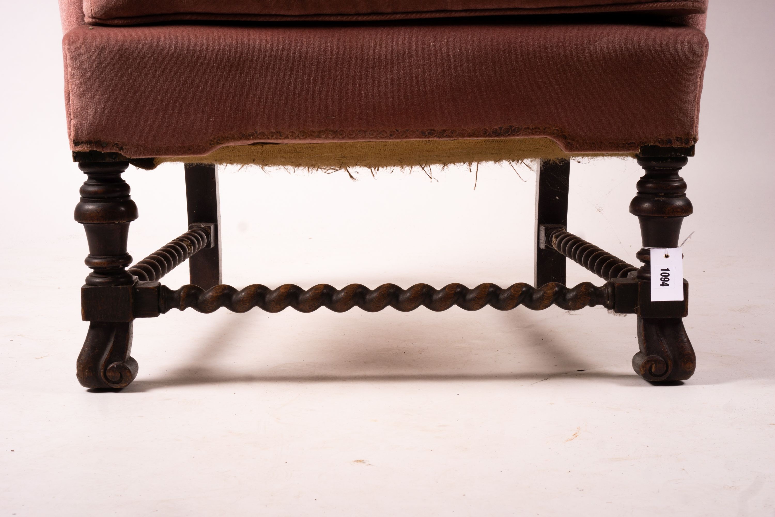 An early 20th century Jacobean revival upholstered wing armchair, width 84cm, depth 90cm, height 128cm